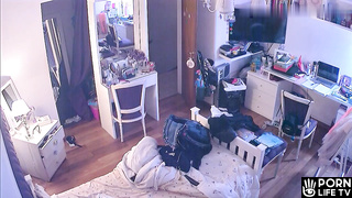 French redhead girl gets dressed in her room