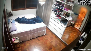 Busty blonde woman gets dressed in her room