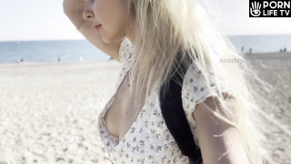 Blondy girl flashing boobs on public beach. Downblouse